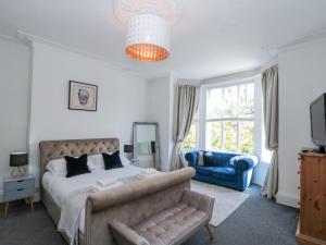 a bedroom with a king sized bed and a couch at Royal Victoria House in Scarborough