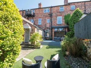 an internal view of a garden with chairs and a building at Royal Victoria House in Scarborough
