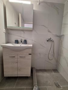 a white bathroom with a sink and a shower at Aegean Traditional Suite Ιn Glinado in Glinado Naxos +23 photos