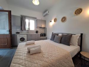 a bedroom with a bed with two towels on it at Aegean Traditional Suite Ιn Glinado in Glinado Naxos