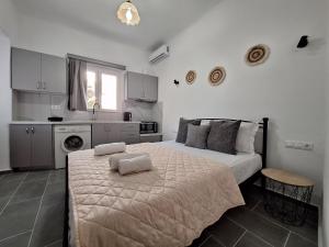 a bedroom with a bed with two towels on it at Aegean Traditional Suite Ιn Glinado in Glinado Naxos