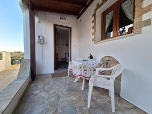 a table and chairs on the patio of a house at Aegean Traditional Suite Ιn Glinado in Glinado Naxos