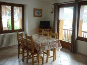 a dining room with a table and chairs and windows at 2 pièces pour 4 pers, Sud-Est à Valloire, avec Wifi - FR-1-263-83 in Valloire