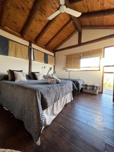 a bedroom with two beds and a ceiling fan at CABAÑA STANDARD pileta-cochera in Río Ceballos +33 photos