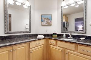 a bathroom with a sink and two mirrors at Ameila Island Plantation condo with beach access, private patio and pool. in Fernandina Beach +9 photos