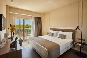 a hotel room with a bed and a balcony at Silken Turcosa 3 Sup in Castellón de la Plana