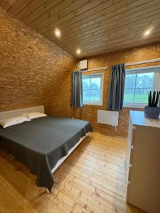 a bedroom with a bed in a brick wall at Rebäse Puhkemaja in Kokemäe