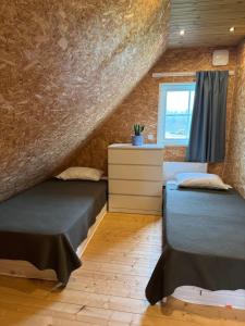 a room with two beds and a window at Rebäse Puhkemaja in Kokemäe +6 photos