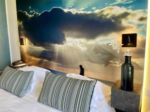 a bedroom with a wall mural of a cloud at Best Western ARThotel in Le Havre