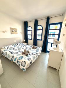 a bedroom with a bed in a room with windows at Maspalomas Casa Oceano in Maspalomas +19 photos