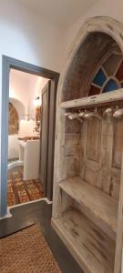 a room with an open door to a room with a table at Aliori art caves in Aegiali