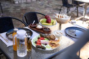a table with a plate of food on it at Villa EM in Gjirokastër