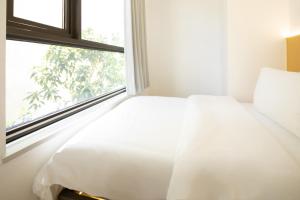 Postel nebo postele na pokoji v ubytování Amanda Hotel堆谷里酒店