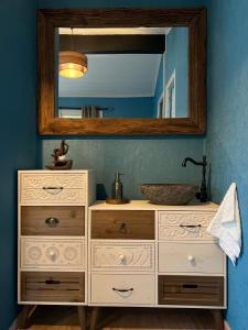a bathroom vanity with a sink and a mirror at Camping La Tourelle in Plémy +47 photos