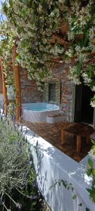a brick building with a table and a bench at Aliori art caves in Aegiali