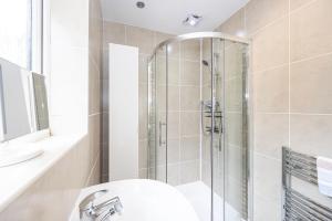 a bathroom with a shower and a sink at Modern Family Home in South Manchester/Stockport in Cheadle +4 photos
