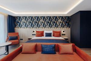 a bedroom with a large bed with orange and blue pillows at Exe Casablanca in Casablanca