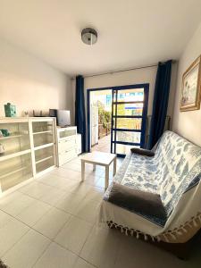 a bedroom with a bed and a door to a patio at Maspalomas Casa Oceano in Maspalomas