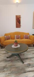 a living room with a couch and a coffee table at Aliori art caves in Aegiali