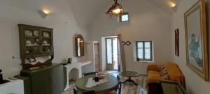 a living room with a couch and a table at Aliori art caves in Aegiali
