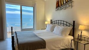 a bedroom with a bed with a view of the ocean at Beira Mar by Check-in Portugal in Albufeira