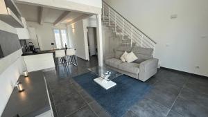 a living room with a couch and a table at Elegant loft by the sea in Punta Marina