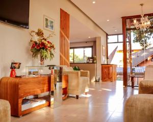 a living room with a couch and a table at Hotel Pequeno Bosque in Gramado