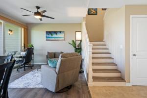 a living room with a stairway and a chair at Big Island Na Hale O Keauhou E3 by Coldwell Banker Island Vacations in Kailua-Kona