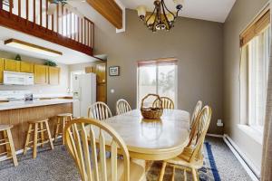 a kitchen and dining room with a table and chairs at Aspen Village Condo #32 in McCall