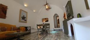 a living room with a couch and a fireplace at Aliori art caves in Aegiali