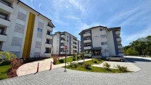a car parked in a parking lot next to buildings at Luxe Apartman Sokobanja in Soko Banja