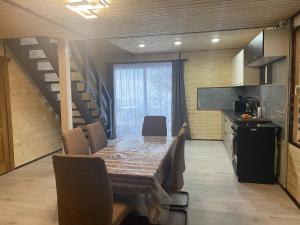 a dining room with a table and a kitchen at Шпінь 4 in Vorokhta