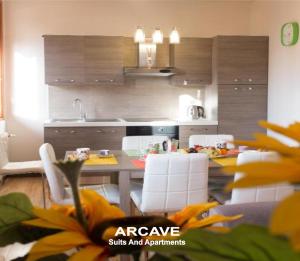 a kitchen with a table and chairs and a kitchen with a kitchen at Vera Luxury Apartment in Sirmione