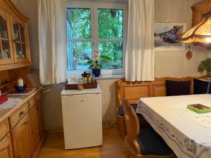 a kitchen with a table and a white refrigerator at Apartment Thomabauerhof in Oberzeiring