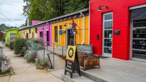 a row of brightly colored buildings on a street at The Artful Way Hotel in Asheville