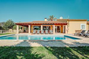 a house with a swimming pool and a gazebo at Ca na Margalida in Manacor
