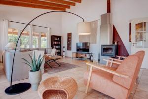 a living room with a couch and a fireplace at Ca na Margalida in Manacor