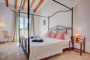 a bedroom with a large bed with a black frame at Ca na Margalida in Manacor +49 photos