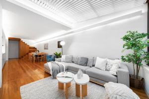 a living room with a couch and a table at Designer Darlinghurst Retreat Garage Parking in Sydney