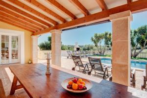 a bowl of fruit on a wooden table on a patio at Ca na Margalida in Manacor