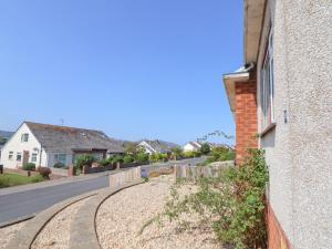 a house with a road next to a building at Bryn Bach in Colwyn Bay