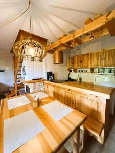 a kitchen with wooden cabinets and a wooden table at Masuria Hut in Mrągowo +37 photos