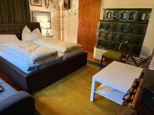 a bedroom with a bed and a table in it at Apartment Thomabauerhof in Oberzeiring