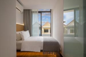 Postel nebo postele na pokoji v ubytování Amanda Hotel堆谷里酒店