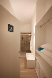 a small bathroom with a shower and a bed at Le chiavi di Parthenope in Naples