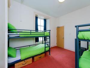 a dorm room with two bunk beds in it at YHA Coniston Coppermines in Coniston