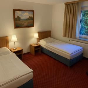 Postel nebo postele na pokoji v ubytování Hotel Schillerplatz