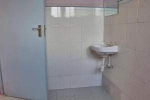 a bathroom with a sink and a mirror at 136 Boutique Address Hotel in Nairobi