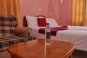 a bottle of water on a table in a living room at 136 Boutique Address Hotel in Nairobi +1 photo