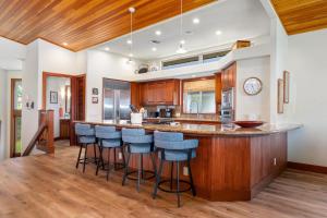 una cucina con una grande isola con sgabelli da bar di Big Island Villages at Mauna Lani Resort 325 by Coldwell Banker Island Vacations a Waikoloa